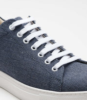Close-up of the Vegan Hemp Sneaker V1 showcasing its blue hemp fabric and white laces.