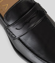 Vegan Loafer - Man showing the black leather upper and distinctive U-shaped stitching detail.