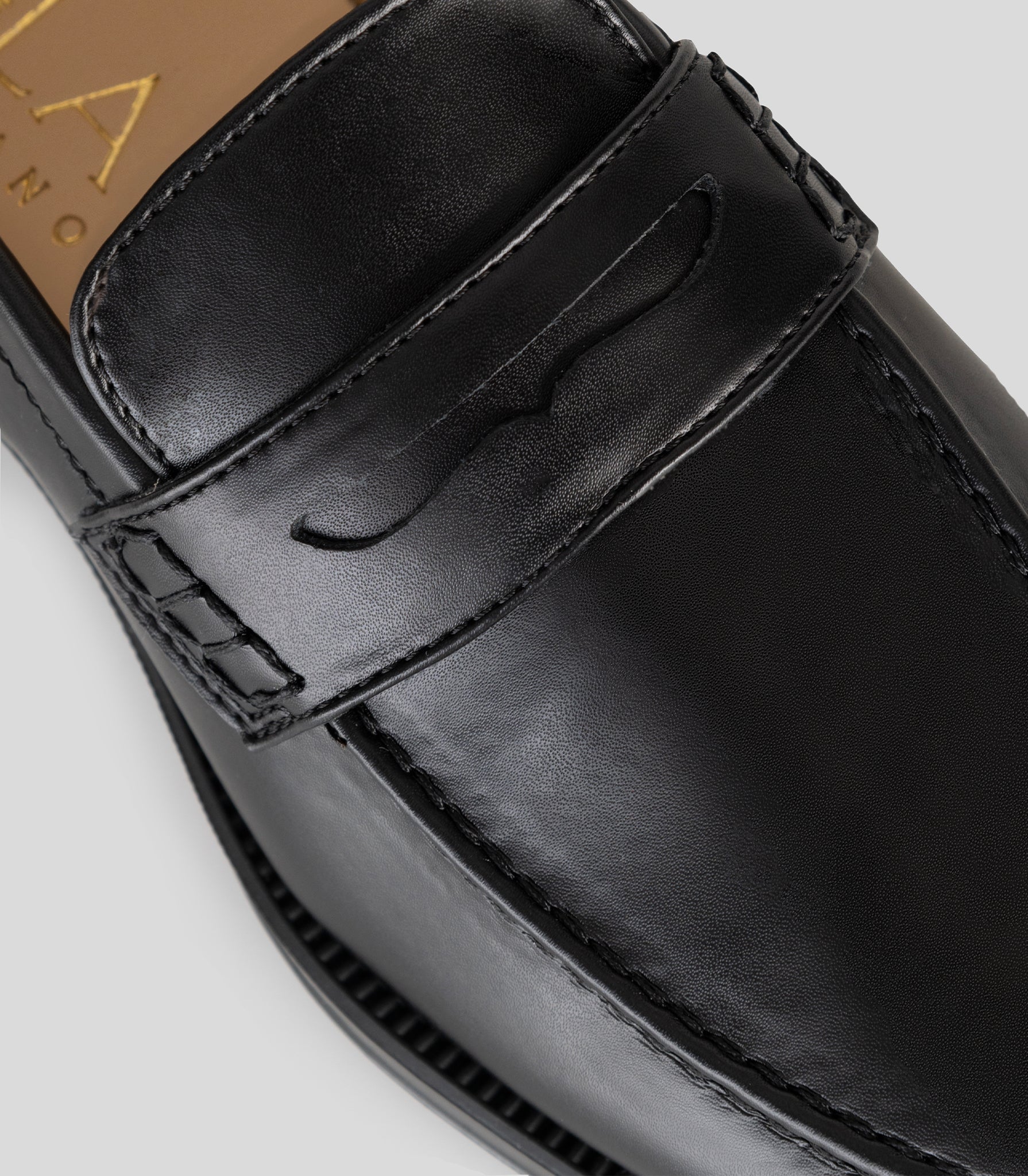 Vegan Loafer - Man showing the black leather upper and distinctive U-shaped stitching detail.