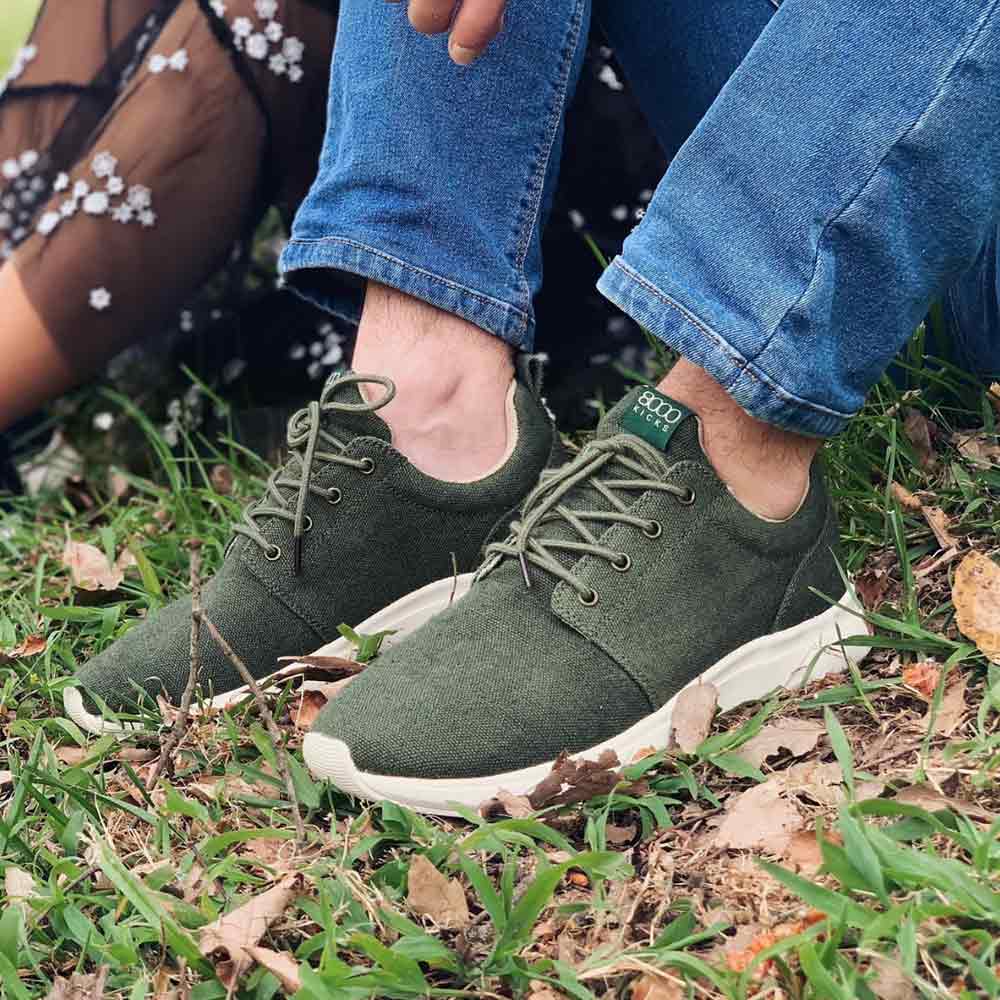 A person wearing the unisex 8000 Kicks Low Top Explorer V2 Green sneakers outdoors, emphasizing the comfortable and sustainable hemp design. Keywords: Hemp Sneaker, Hemp Shoes, Sustainable sneakers.