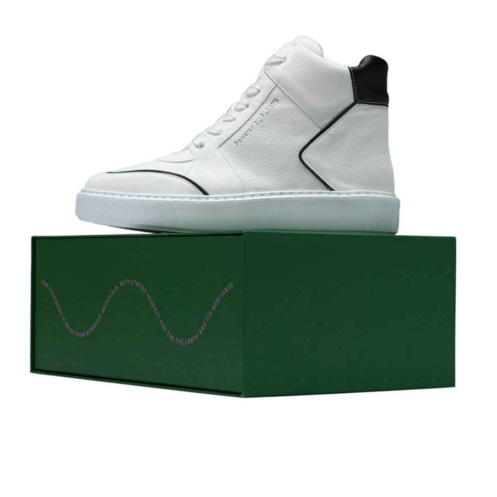 Agazi EMI High Top sneakers in white with black accents, placed on a green shoe box with eco-friendly message. Sustainability shoes. Environment friendly shoes.