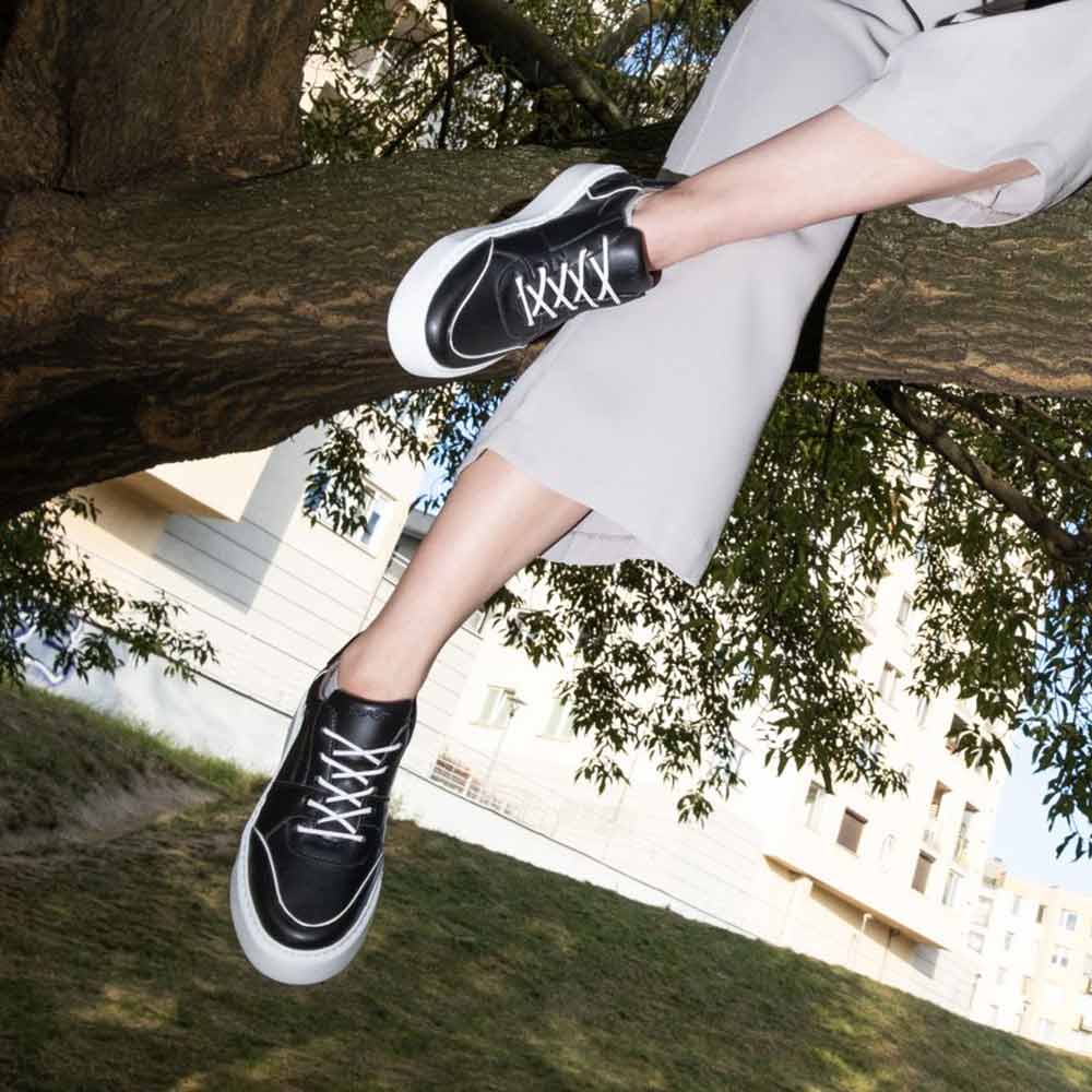 AGAZI EMI Low Black sneakers in an outdoor setting, highlighting their durability and eco-friendly design. Sustainability Shoes. Environment friendly shoes.