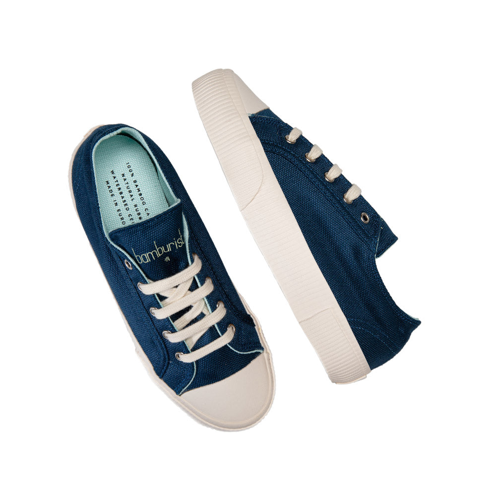 Top-down view of Bamburista Blue sneakers: A top-down view of the women's sneakers showing the blue bamboo textile, white laces, and the brand logo on the tongue.