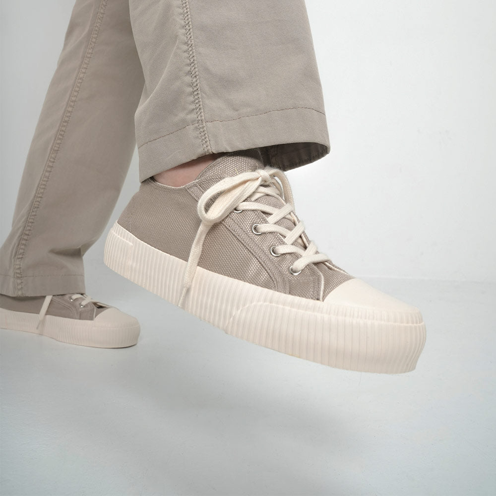 Bamburista Grey Sneaker Lifestyle: A person wearing the Bamburista Grey sneaker with light-colored pants, illustrating the stylish and eco-friendly design of the sustainable shoe.