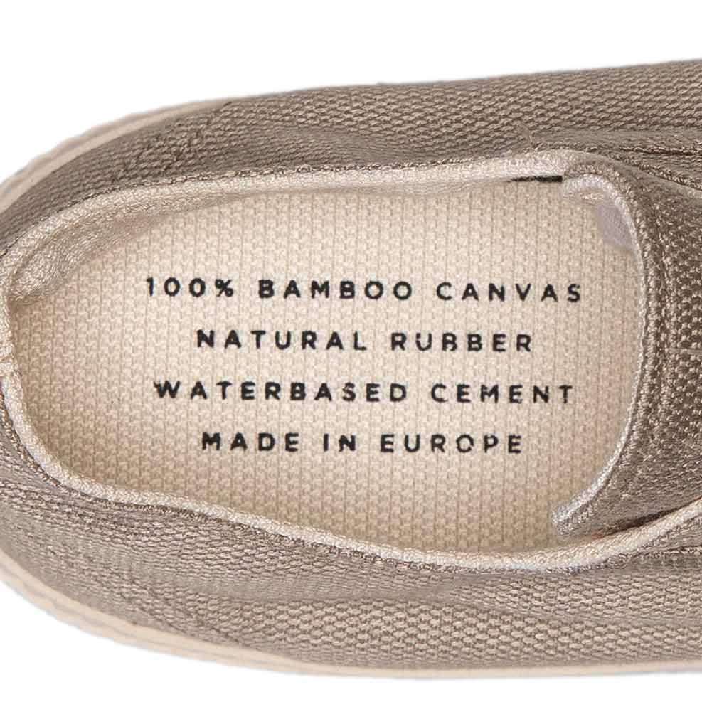 Bamburista Grey Sneaker Inner Sole: Close-up of the inner sole of the Bamburista Grey sneaker, highlighting the text "100% Bamboo Canvas, Natural Rubber, Waterbased Cement, Made in Europe."