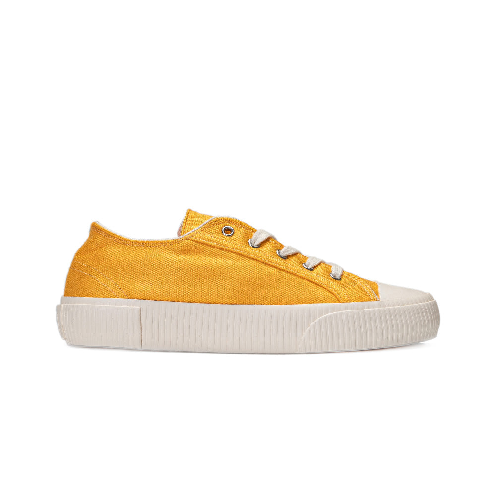 Side view of Bamburista women's sneaker in yellow, showcasing its bamboo textile upper and sustainable design.