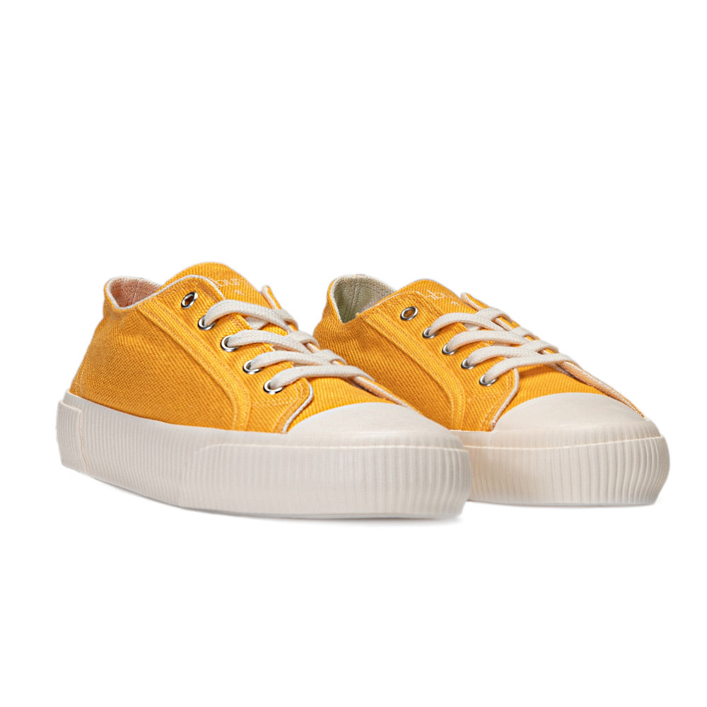 Pair of Bamburista women's yellow sneakers with bamboo fiber textile, highlighting their sustainable shoe design.