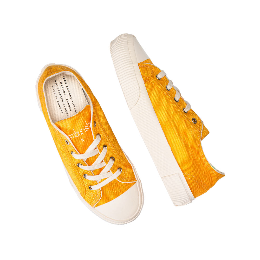 Top view of a pair of Bamburista yellow sneakers laid out, emphasizing the bamboo textile and eco-friendly materials.