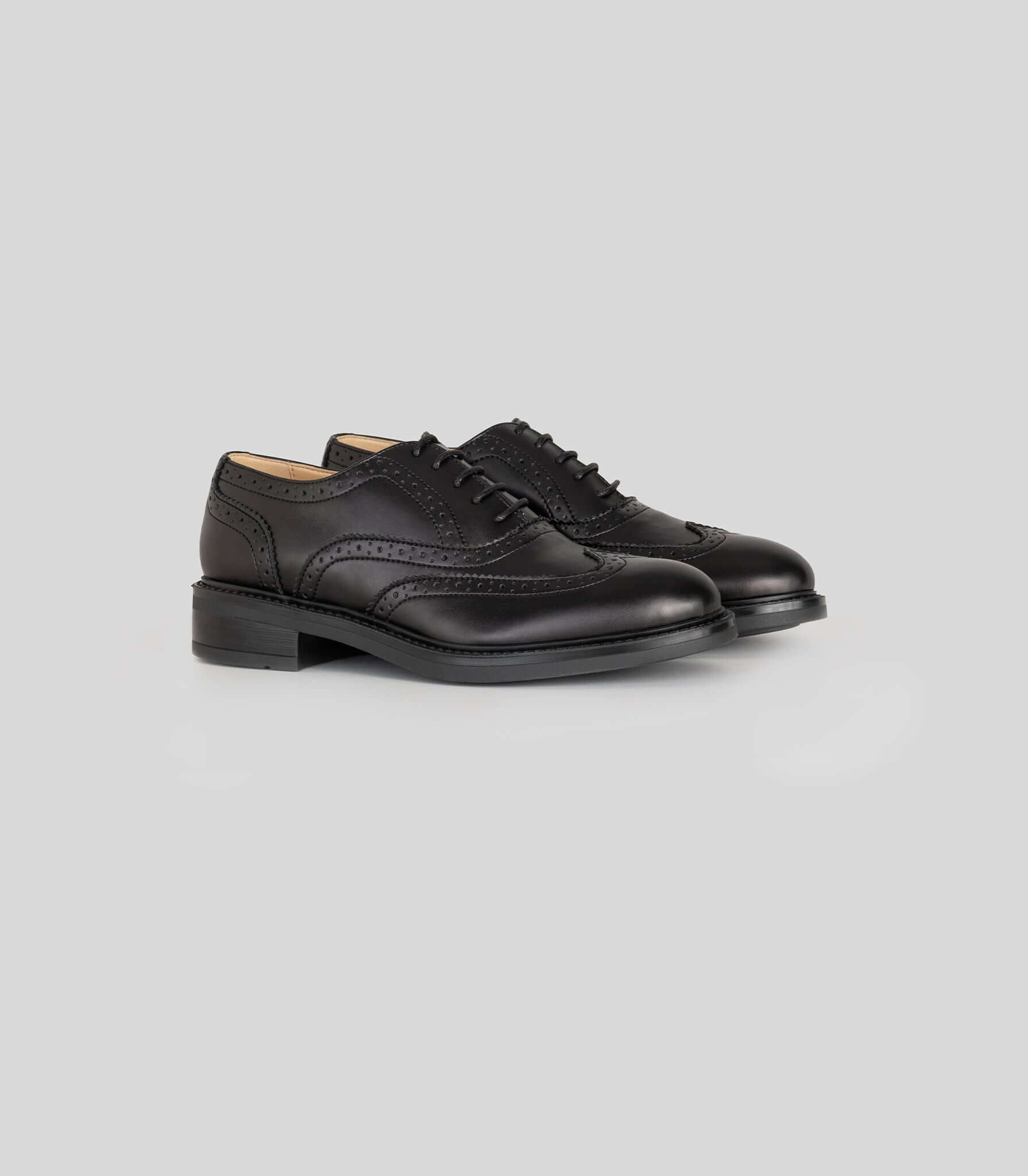 Vegan Oxford Brogue - Woman in black leather with broguing detail for elegant office and casual wear.