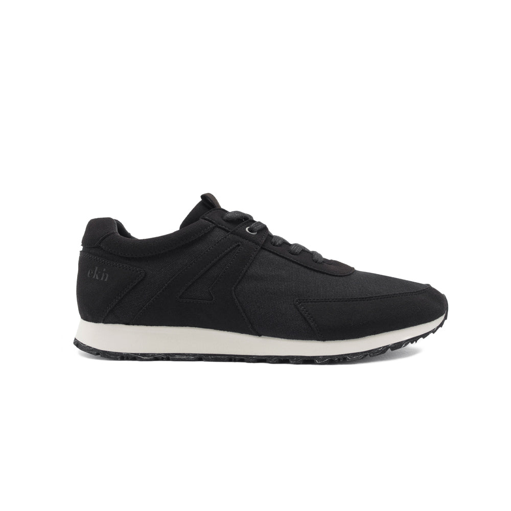 Side view of EKN Low Seed Runner Black vegan sustainable shoes, showcasing sleek design and eco-friendly materials.