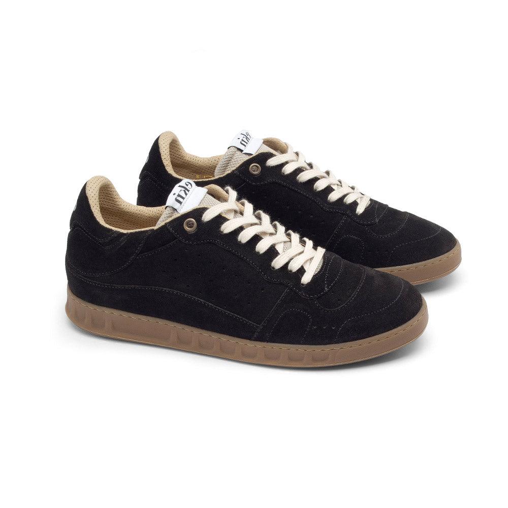 EKN Alder Black sneakers positioned at an angle to showcase both the front and side profiles.