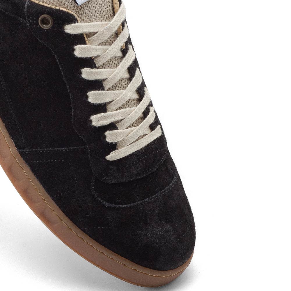 Detailed shot of the toe area of EKN Alder Black sneakers, highlighting the premium black suede material.