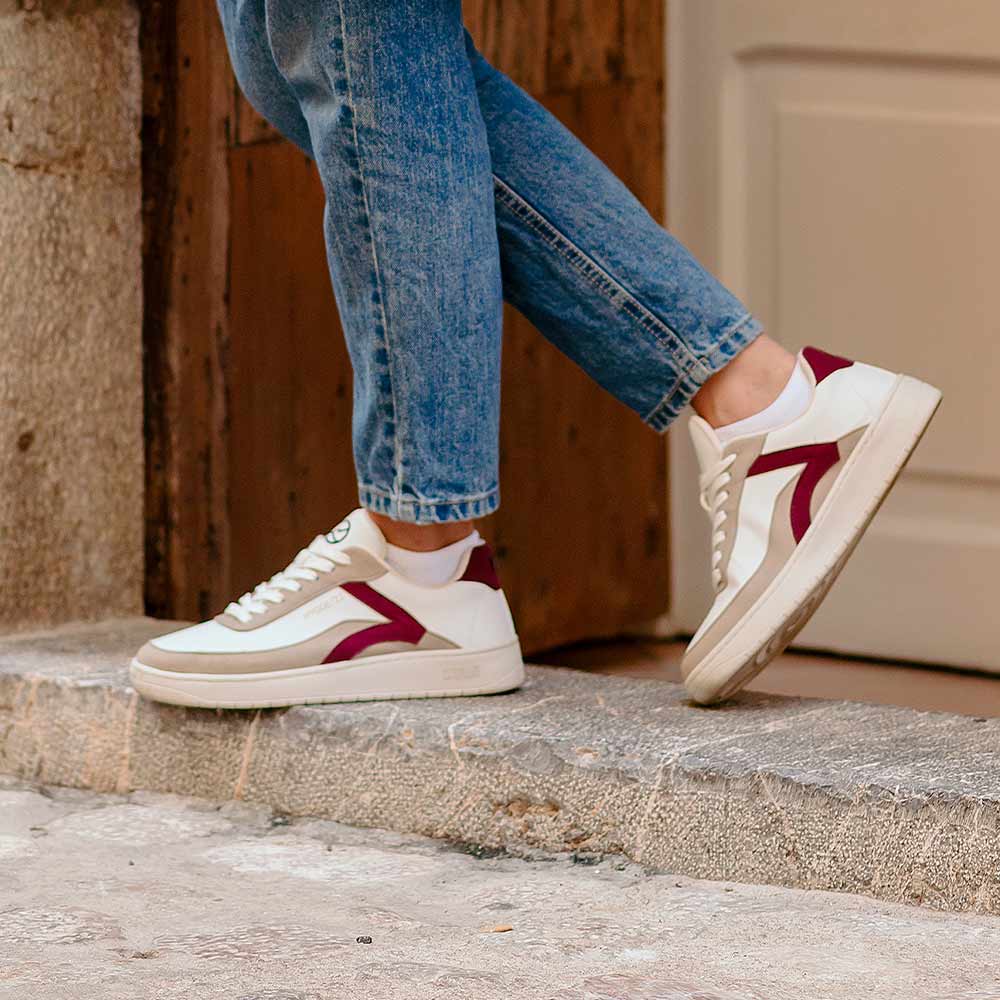 Person wearing Kumi Bordeaux recycled material sneakers, demonstrating the fit and style.