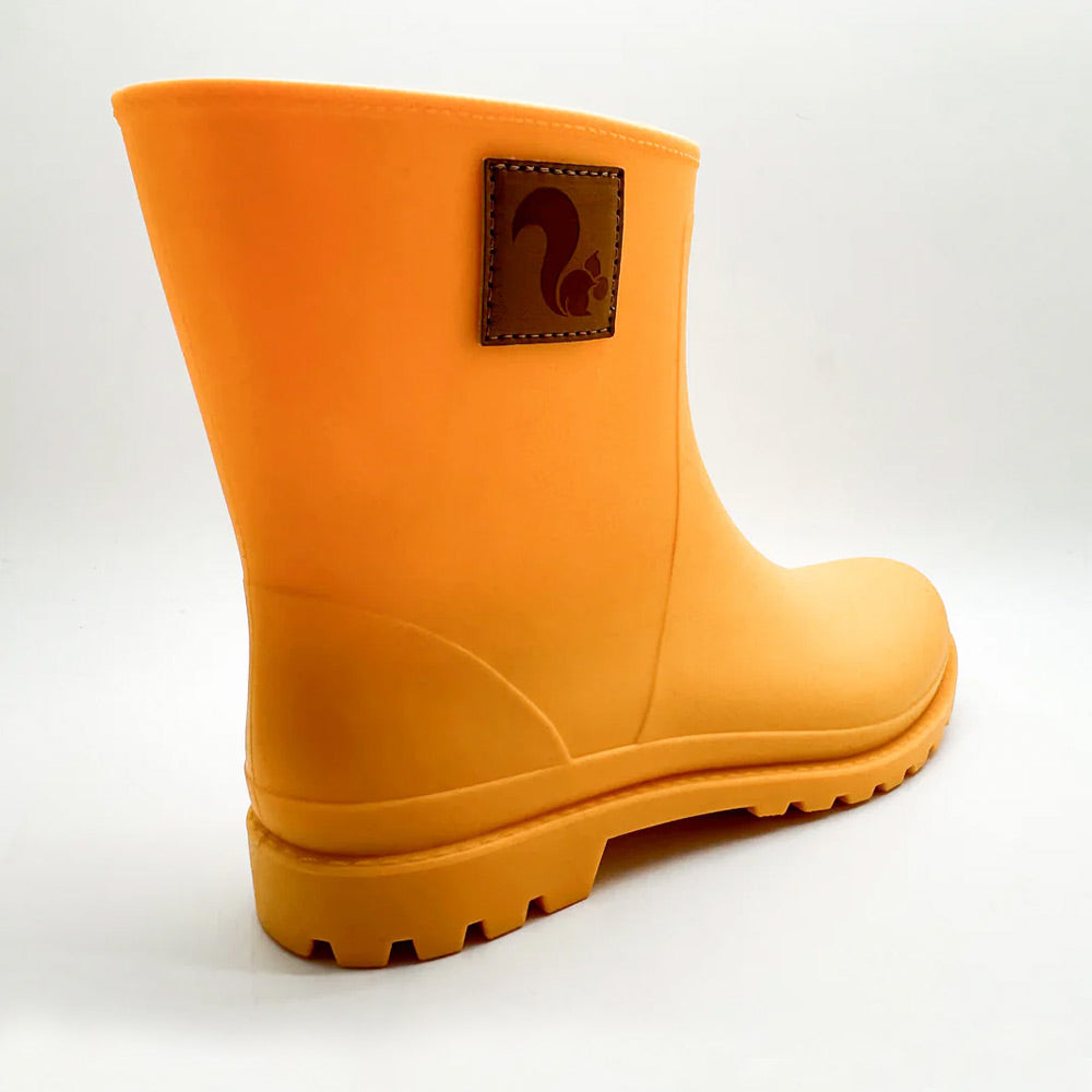 Rear angle of Thies Bio Rain Boots in Orange, highlighting the vegan boots durable build.