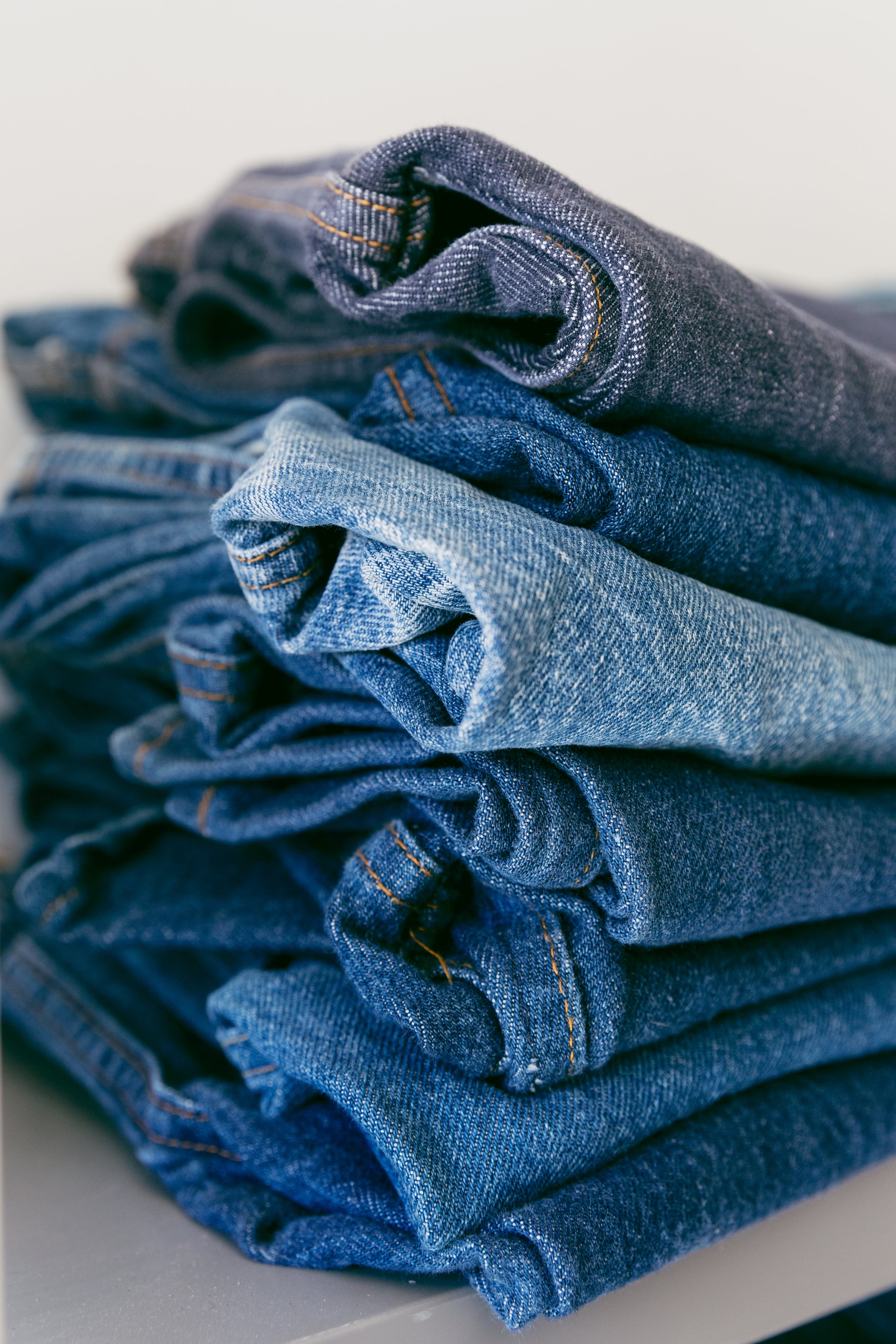 a-pile-of-denim-jeans-in-different-shades-of-blue.jpg